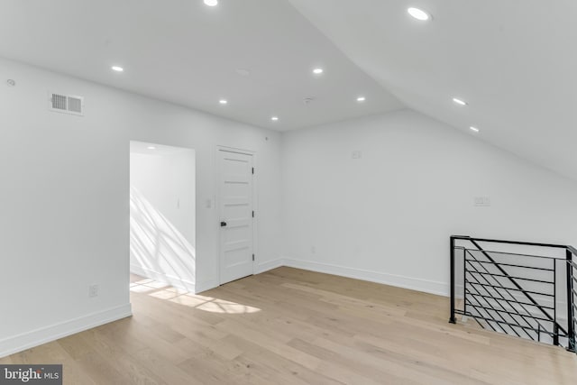 bonus room featuring lofted ceiling and light wood-type flooring