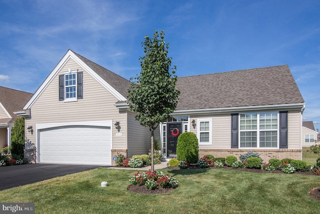 view of front facade with a garage and a front yard