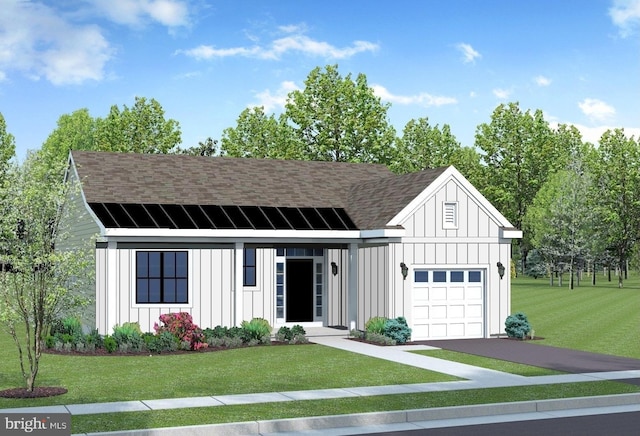 view of front of house with a garage and a front lawn