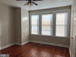 spare room with ceiling fan, dark hardwood / wood-style flooring, and a healthy amount of sunlight