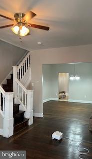 interior space with ceiling fan and dark hardwood / wood-style floors