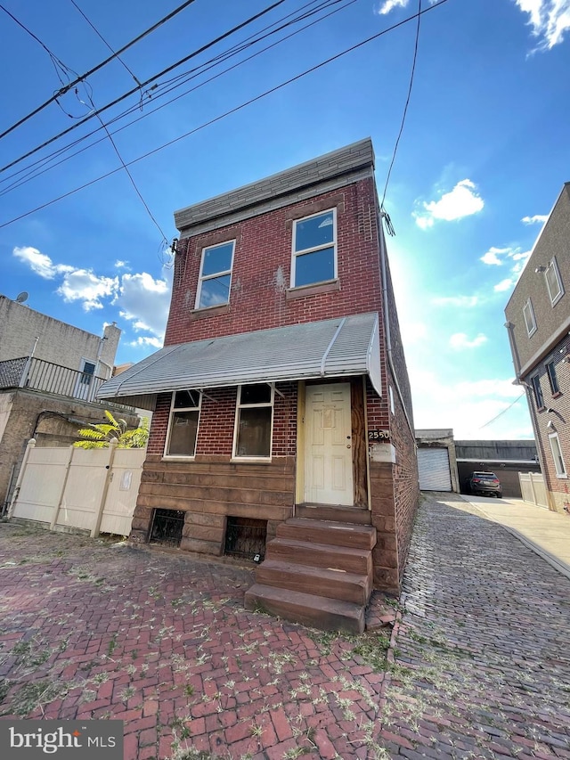 view of front of house featuring a garage and an outdoor structure