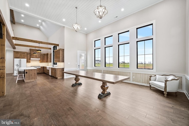 exercise area with wood ceiling, sink, a chandelier, a high ceiling, and dark hardwood / wood-style floors