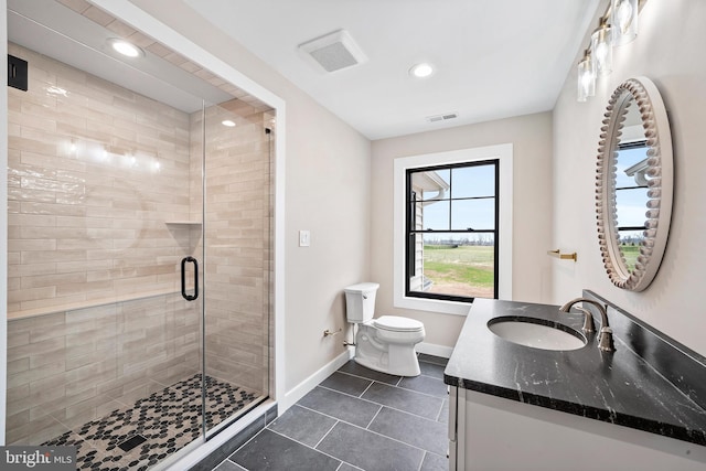 bathroom featuring tile patterned flooring, vanity, toilet, and an enclosed shower