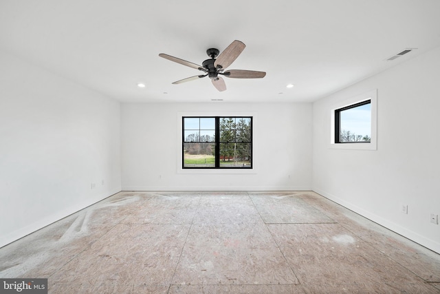 spare room featuring ceiling fan and a healthy amount of sunlight