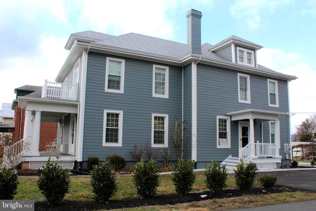 view of front of house with a balcony and covered porch