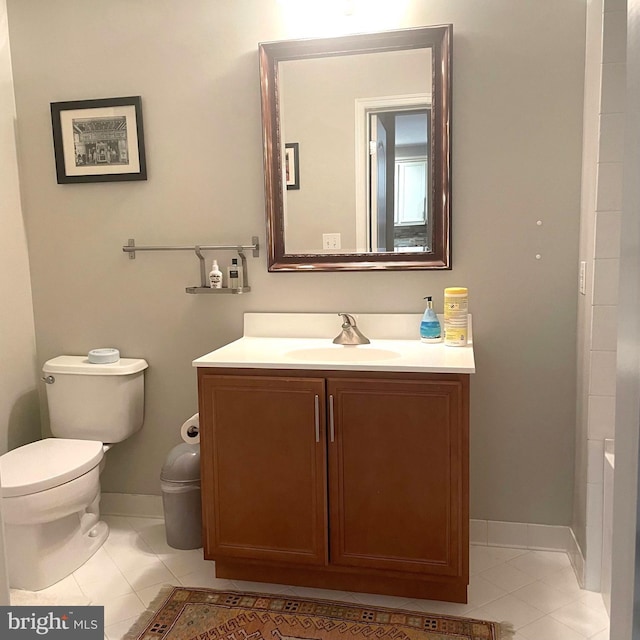 bathroom with tile patterned flooring, vanity, and toilet