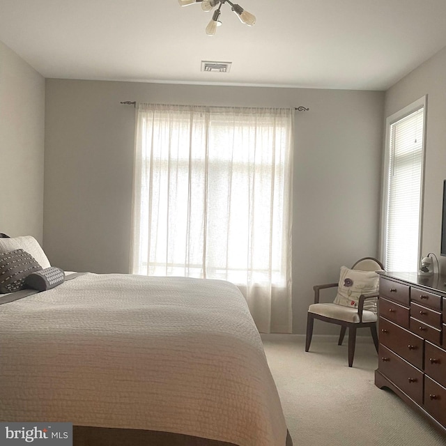 bedroom with ceiling fan and light colored carpet