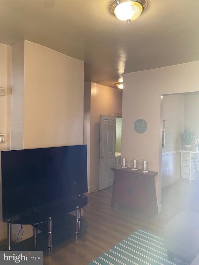 unfurnished living room with dark wood-type flooring