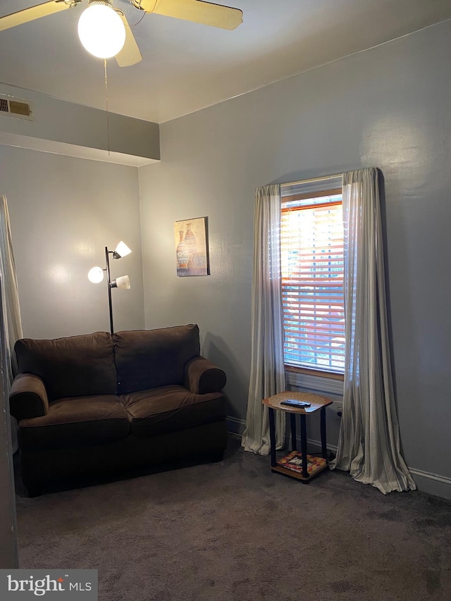 living room with dark carpet and ceiling fan