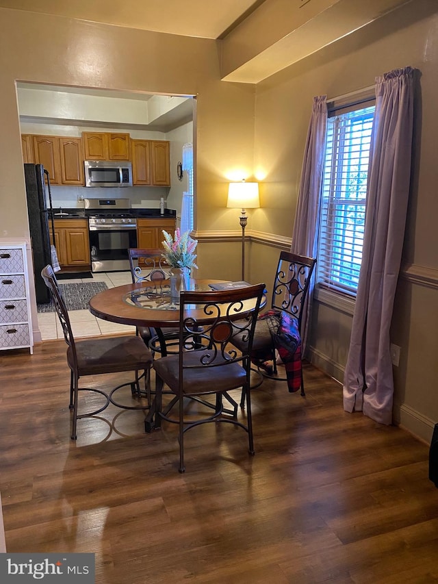 dining space featuring dark hardwood / wood-style floors