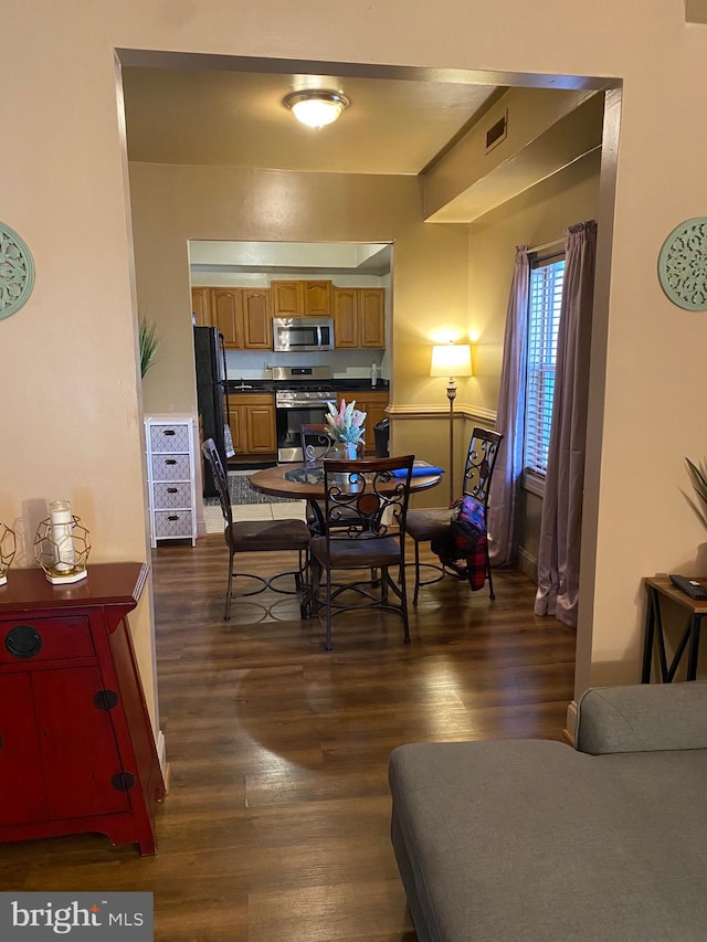 dining space with dark wood-type flooring