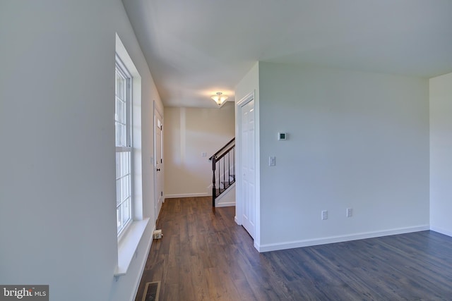 entryway featuring stairway, dark wood finished floors, visible vents, and baseboards