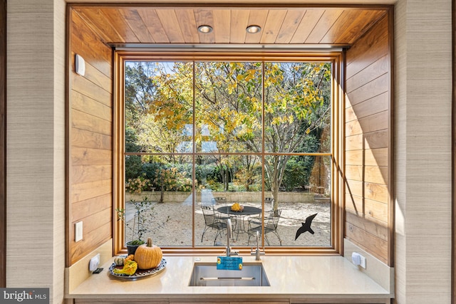 doorway with wood walls and wood ceiling