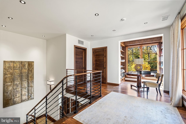 corridor with dark hardwood / wood-style flooring