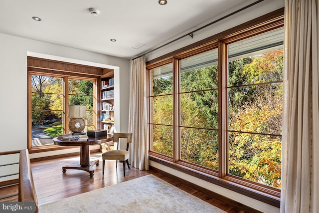 home office with dark hardwood / wood-style flooring