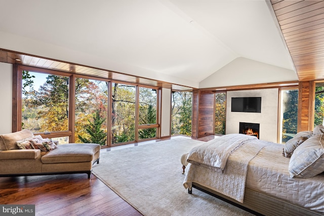 bedroom with dark wood-type flooring and vaulted ceiling