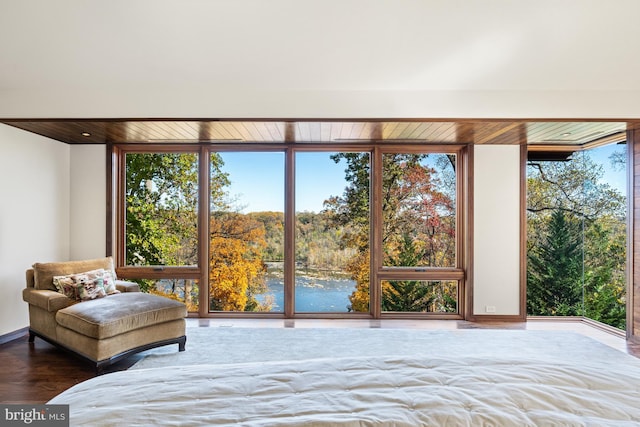 bedroom with dark wood-type flooring and a wall of windows