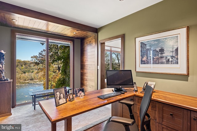 home office with plenty of natural light, wood walls, and beamed ceiling