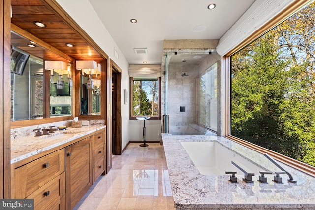 bathroom featuring vanity, tile floors, and separate shower and tub