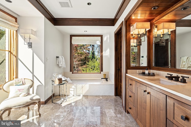 bathroom with a tub, tile flooring, vanity, and a wealth of natural light