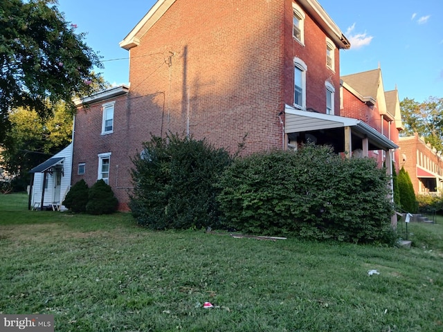 view of side of property with a yard