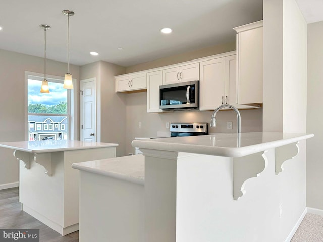 kitchen with electric stove, light hardwood / wood-style flooring, sink, decorative light fixtures, and white cabinetry