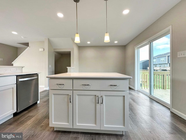 kitchen featuring decorative light fixtures, stainless steel dishwasher, white cabinetry, dark hardwood / wood-style flooring, and a kitchen island