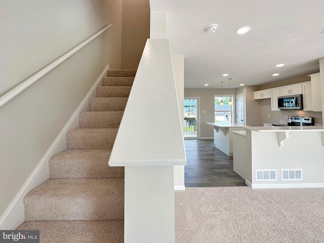 stairs with wood-type flooring