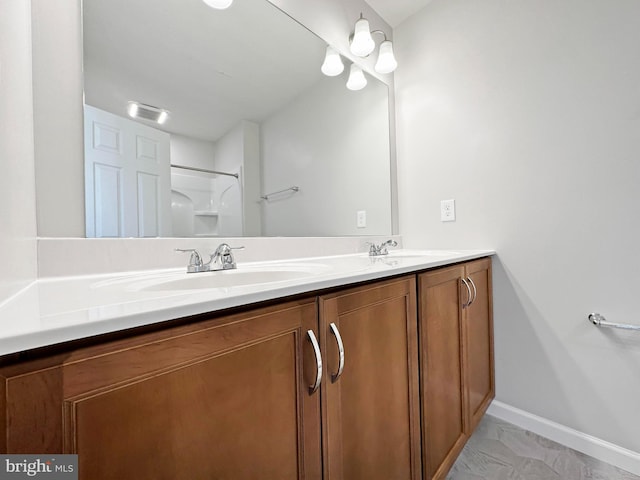 bathroom with dual vanity and tile patterned floors