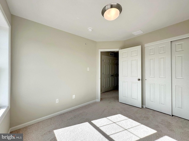 unfurnished bedroom featuring carpet and a closet