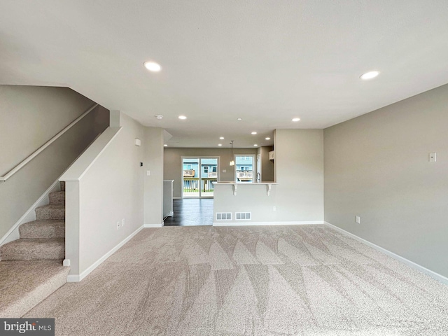 unfurnished living room featuring carpet flooring