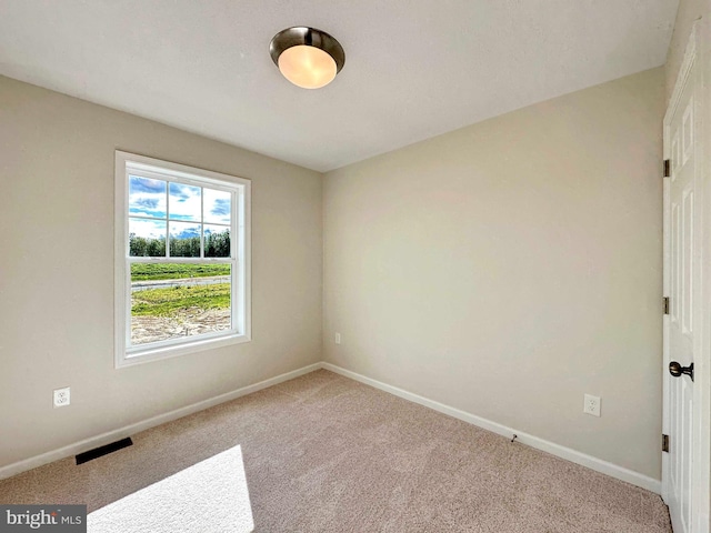 spare room featuring carpet