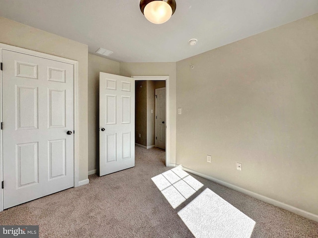 unfurnished bedroom with carpet floors