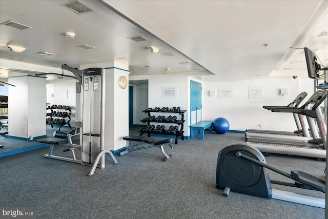 workout area featuring dark carpet