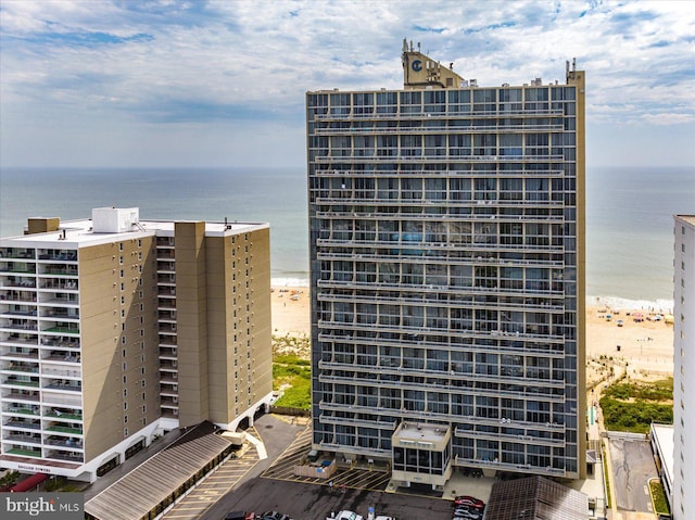 view of property featuring a water view and a beach view