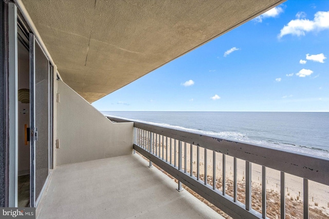 balcony with a beach view and a water view