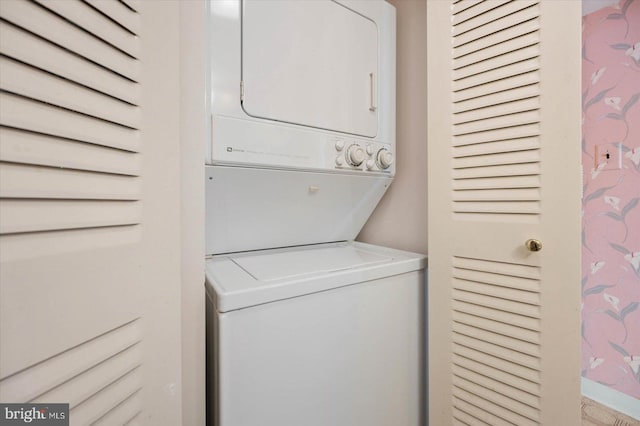 clothes washing area with stacked washer and clothes dryer