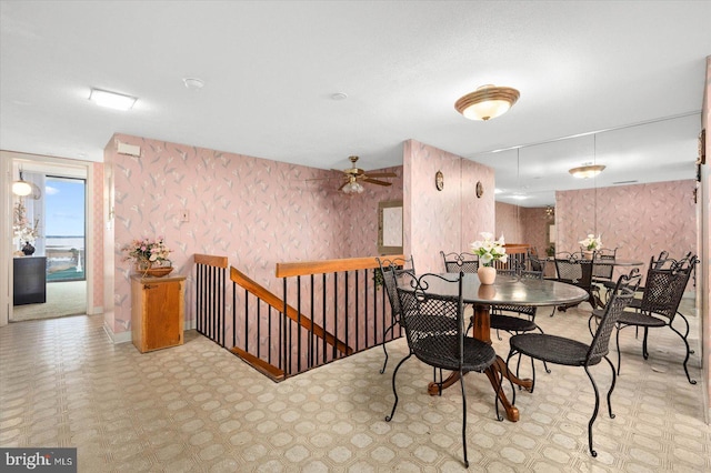 dining space featuring ceiling fan and light tile floors