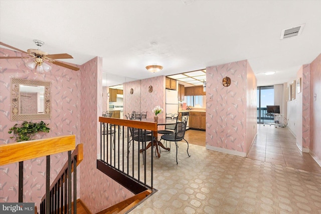 interior space featuring ceiling fan and light tile floors