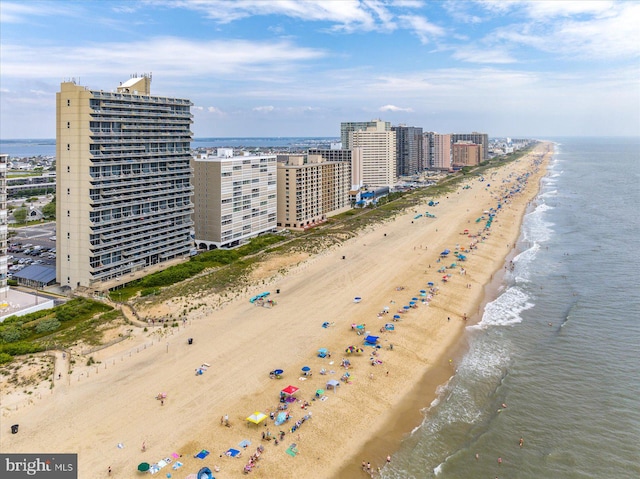 aerial view with a water view and a beach view