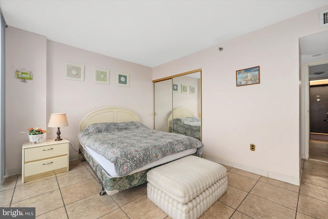 tiled bedroom featuring a closet