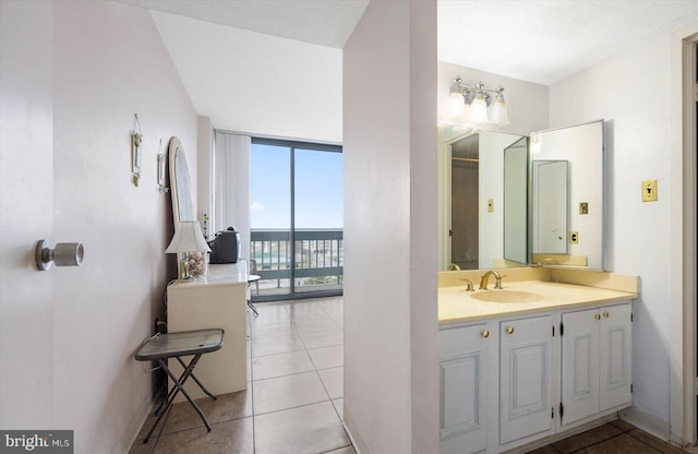 bathroom featuring vanity, tile floors, and expansive windows