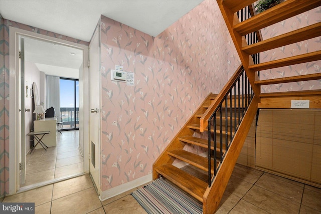 stairway featuring light tile floors