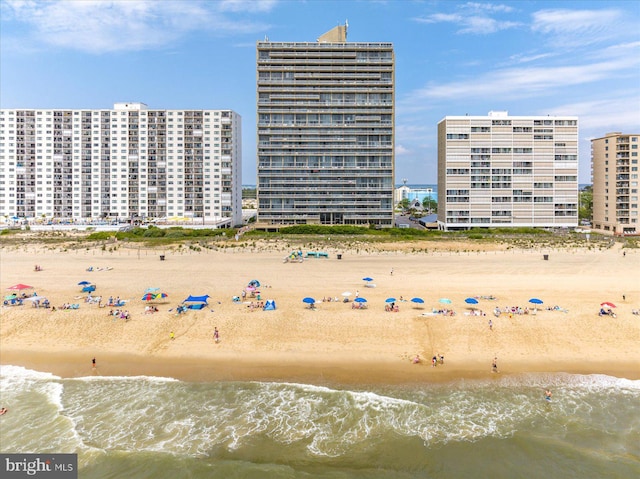 exterior space featuring a beach view and a water view