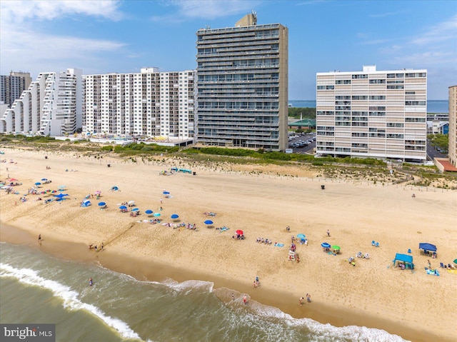 drone / aerial view featuring a view of the beach and a water view