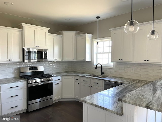 kitchen featuring decorative light fixtures, tasteful backsplash, white cabinets, stainless steel appliances, and light stone countertops