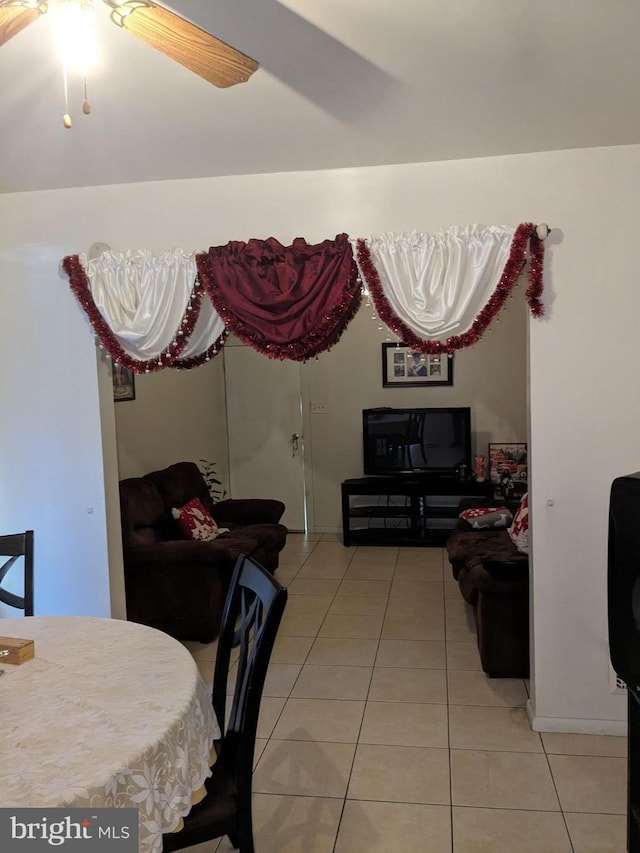 tiled dining room featuring ceiling fan