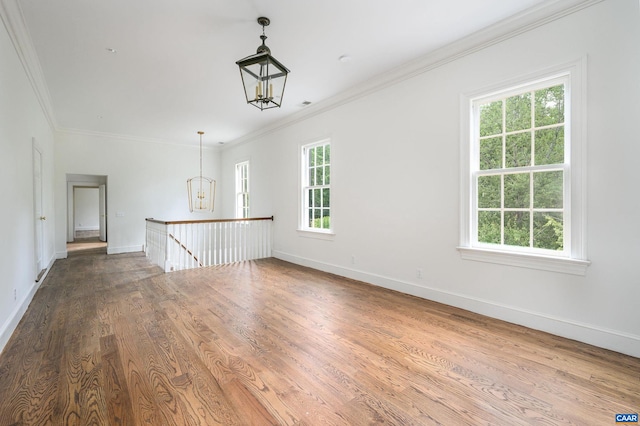 interior space with ornamental molding, plenty of natural light, and dark wood-type flooring