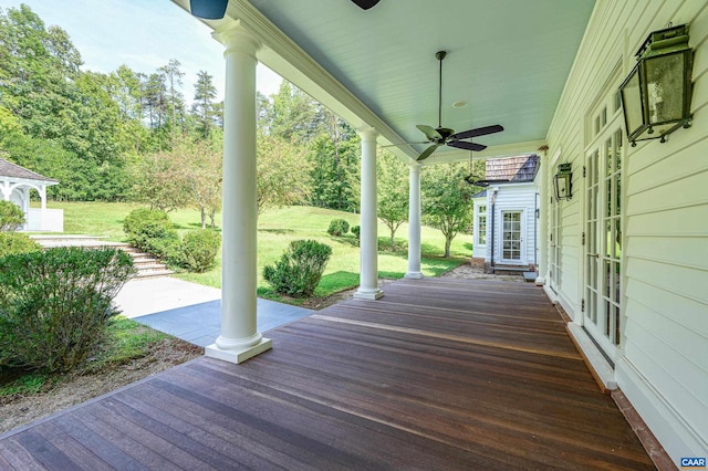 wooden terrace featuring ceiling fan